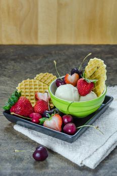 Vanilla ice cream scoops with fresh berries fruit