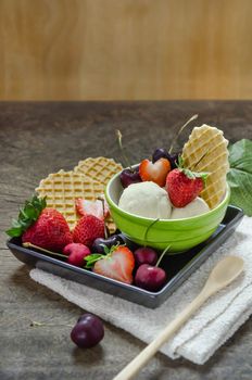 Vanilla ice cream scoops with fresh berries fruit