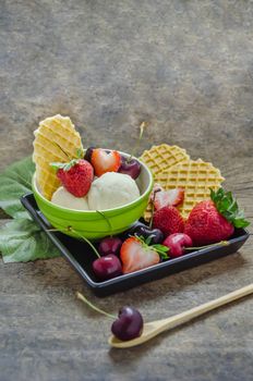 Vanilla ice cream scoops with fresh berries fruit