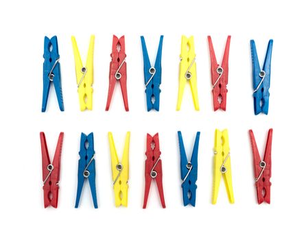 Multicoloured plastic clothes pegs on a white background