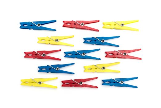 Multicoloured plastic clothes pegs on a white background