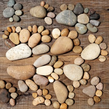 Abstract cute concept on wood background from pebbles, amazing arranged boulder to family of footprint, awesome shape from pebblestone