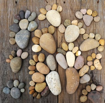 Abstract cute concept on wood background from pebbles, amazing arranged boulder to family of footprint, awesome shape from pebblestone