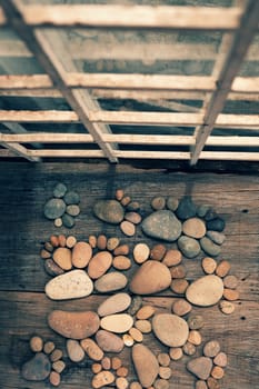 Abstract cute concept on wood backgroup from pebbles, amazing arranged boulder to family of footprint, awesome shape from pebblestone