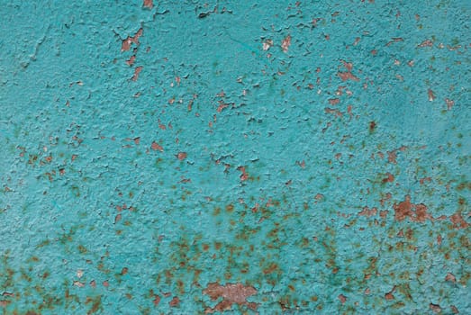 rusty iron surface covered with old chipped emerald color paint, which has long been influenced by different climatic conditions