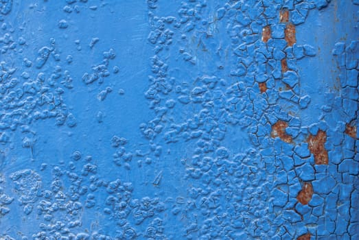 fragment of an iron surface is covered with blue color paint, which has long been under the influence of different climatic conditions