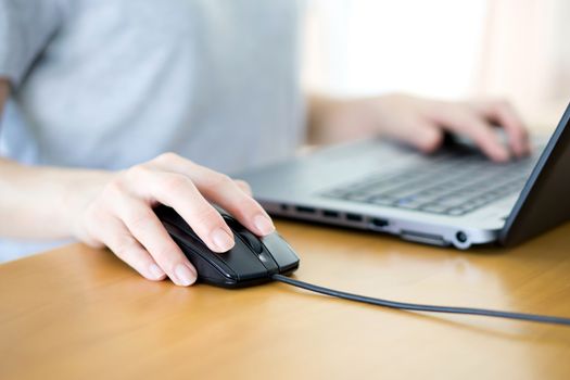 Closeup of woman hand clicking mouse outdoor