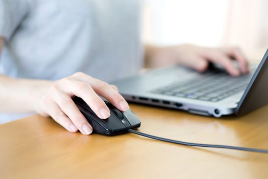 Closeup of woman hand clicking mouse outdoor