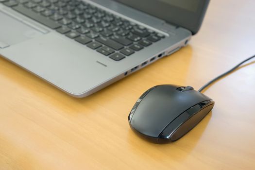 keyboard and mouse on wooden table