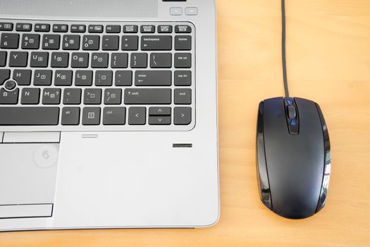 keyboard and mouse on wooden table