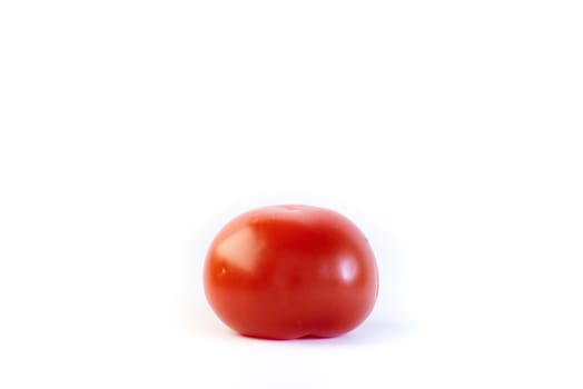 Plain red standard tomato isolated on white.