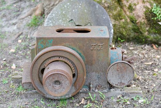 Old rusty engine with one spark plug.