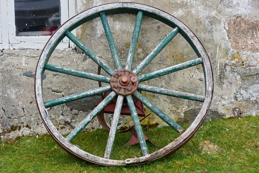 Closeup of wooden wheel with metal parts.