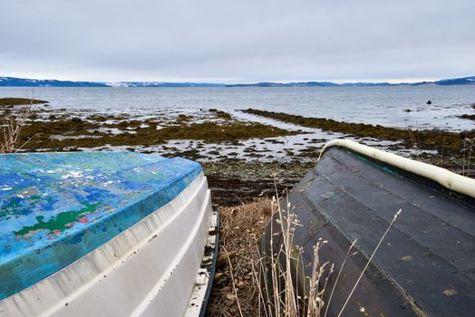 Two old boats lying on the shore
