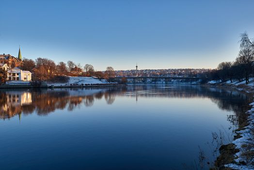 Cityscape of Trondheim, Norway. Showing elgseter bridge and the tyholt tower in the distance.