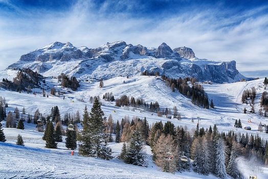 Landscape of the italian alps in a winter morning with clouds at the horizon, Dolomites Alta Badia