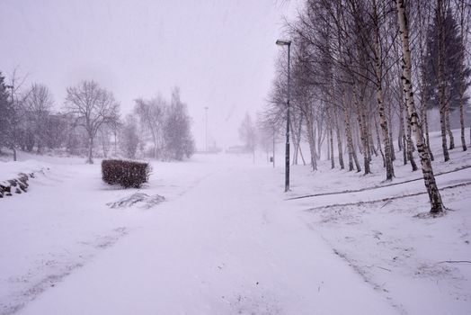 Snowing heavily in a Norwegian neighborhood covering the walkway