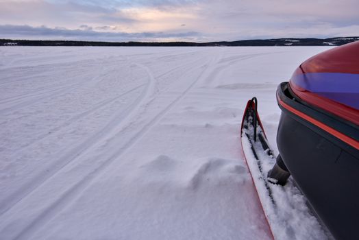 Ready to head over a frozen lake with snowmobile.
