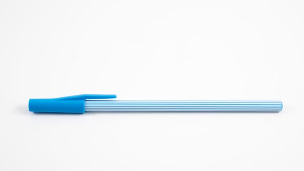 The close up of blue stripe pattern ballpoint pen with blue pen cap.