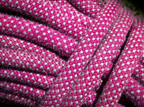 abstract background or texture detail of an old red climbing rope