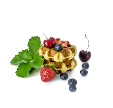 Homemade waffles with mix berries fruit on white background