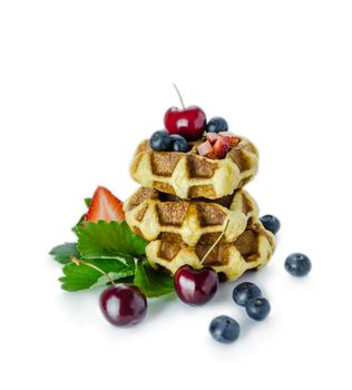 Homemade waffles with mix berries fruit on white background