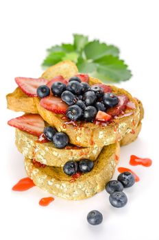 Whole wheat bread with strawberry sauce and fresh berries on white background