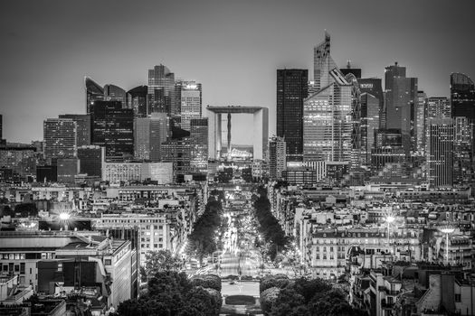 View of La Defence Paris business district from Place Charles De Gaulle at dusk. Black and white image.
