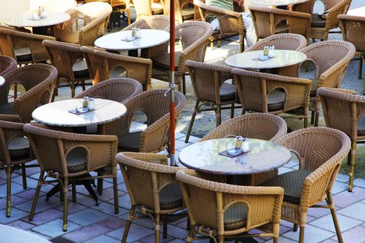 Street view of a Cafe terrace with tables and chairs