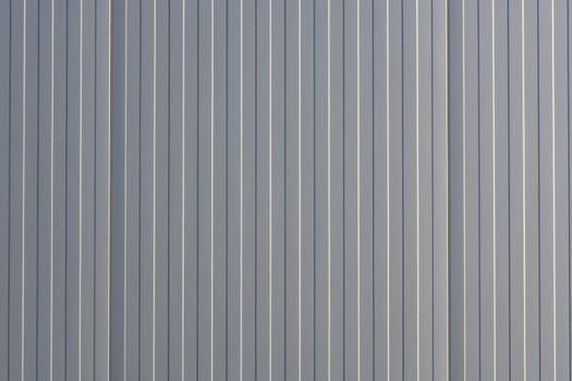 Silver-colored metal wall corrugated sheet metal background.