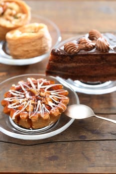 Set of various cakes on nice wooden background