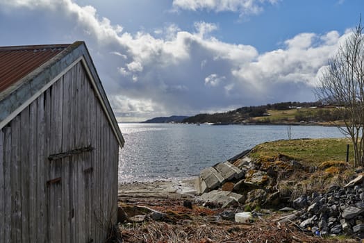 Old boathouse waiting for bad weather in the distance.