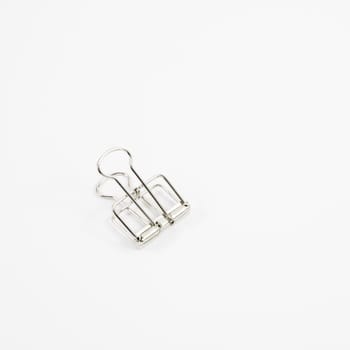 The silver binder clip (paper clip stationery).