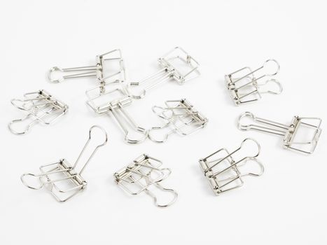 The silver binder clip (paper clip stationery).