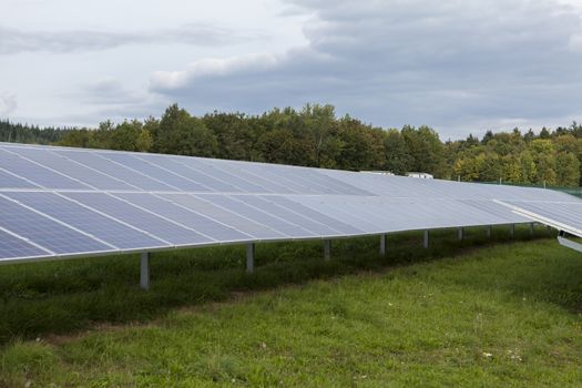 Field with blue siliciom solar cells alternative energy to collect sun energy