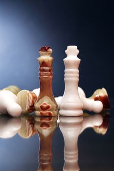 Set of chess pieces made from Onyx against dark background