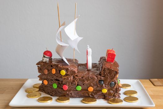 Pirate Chocolate Cake on a white plate. With chocolate coins.