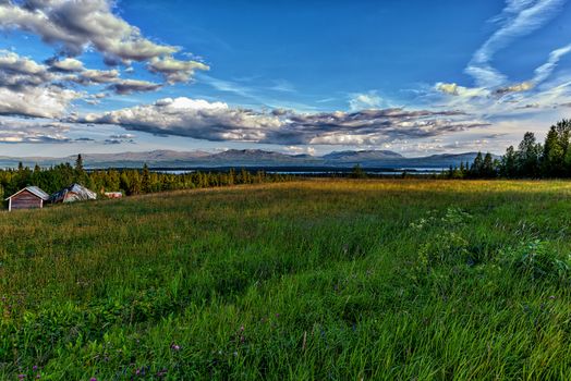 Swedish countryside summer landscape with mountains in the background.