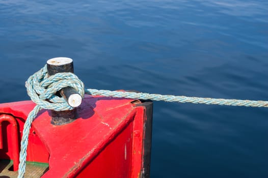 Tight ship cable bound over a mooring bollard.