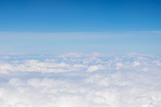 Top view of the fluffy white clouds in the  boundless sky