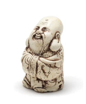 Netsuke of a satisfied man in a dressing gown. Isolated. A miniature sculpture, which was used as a button-like trinket in traditional Japanese clothes kimono kosode, which was devoid of pockets.