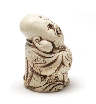 Netsuke of a satisfied man in a dressing gown. Isolated. A miniature sculpture, which was used as a button-like trinket in traditional Japanese clothes kimono kosode, which was devoid of pockets.