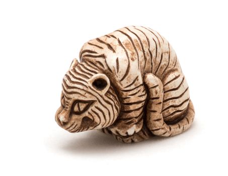 Small Japanese accessory of a seated tiger. A miniature sculpture, which was used as a button-like trinket in traditional Japanese clothes kimono kosode, which was devoid of pockets.