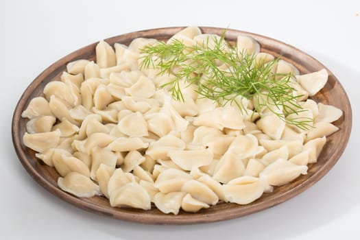 Boiled prepared homemade russian dumplings or pelmeni with beef meat on the plate
