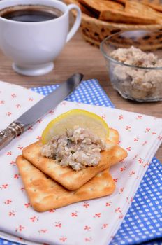 Snack  of fish paste (forshmak) on a cracker with a cup of coffee