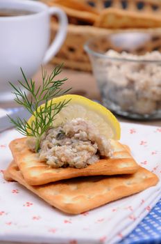 Appetizer of fish paste (forshmak) on crackers  close up
