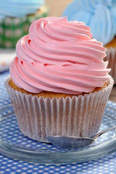 Muffin decorated with a delicate cream closeup