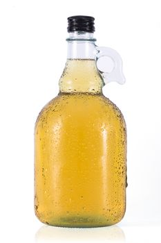 Bottle of cider with water drops on white background