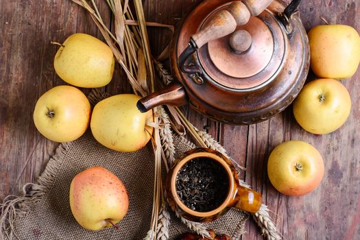 autumn harvest of apples,ears of wheat and kettle