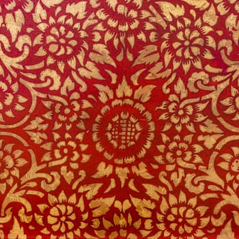 The gold leaf on wood for the background and textures. Thai style pattern on red wall .